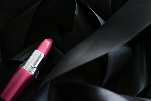 Pink lipstick on black silk background, luxury make-up and beauty cosmetics