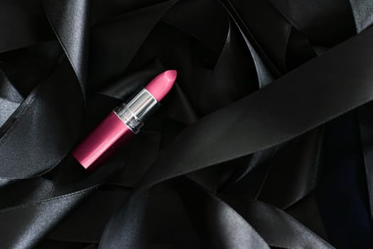 Pink lipstick on black silk background, luxury make-up and beauty cosmetics