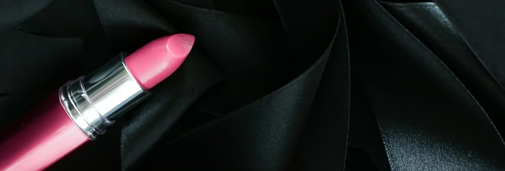 Pink lipstick on black silk background, luxury make-up and beauty cosmetics