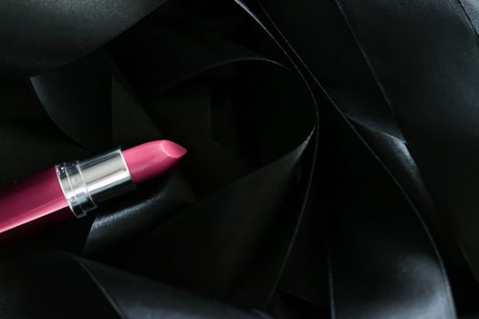 Pink lipstick on black silk background, luxury make-up and beauty cosmetics