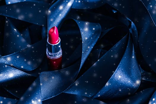 Red lipstick on blue silk and shiny glitter background, luxury make-up and beauty cosmetics