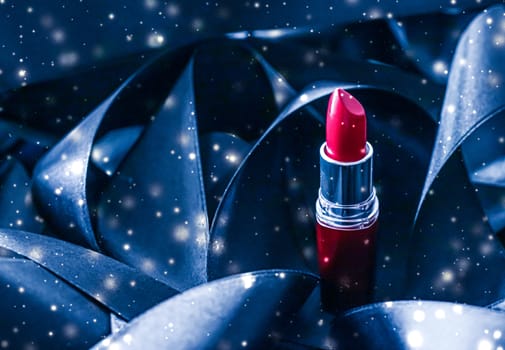 Red lipstick on blue silk and shiny glitter background, luxury make-up and beauty cosmetics