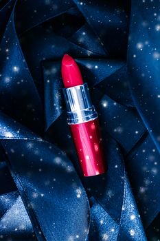 Red lipstick on blue silk and shiny glitter background, luxury make-up and beauty cosmetics