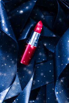 Red lipstick on blue silk and shiny glitter background, luxury make-up and beauty cosmetics