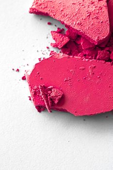 Pink eye shadow powder as makeup palette closeup isolated on white background, crushed cosmetics and beauty textures