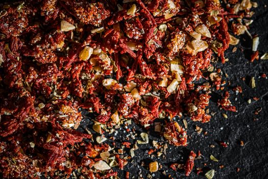 Dried tomato and chili pepper closeup on luxury stone background as flat lay, dry food spices and recipe ingredients