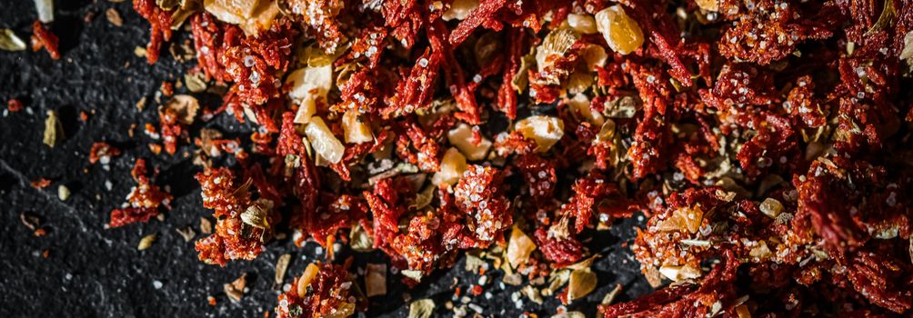 Dried tomato and chili pepper closeup on luxury stone background as flat lay, dry food spices and recipe ingredients