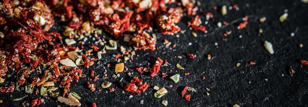 Dried tomato and chili pepper closeup on luxury stone background as flat lay, dry food spices and recipe ingredients