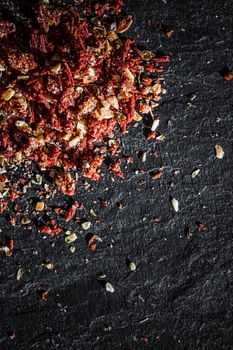 Dried tomato and chili pepper closeup on luxury stone background as flat lay, dry food spices and recipe ingredients