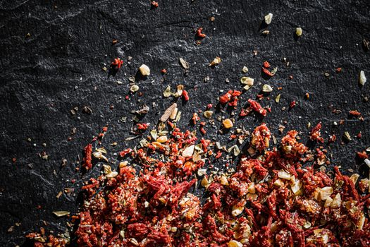 Dried tomato and chili pepper closeup on luxury stone background as flat lay, dry food spices and recipe ingredients