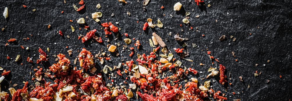 Dried tomato and chili pepper closeup on luxury stone background as flat lay, dry food spices and recipe ingredients