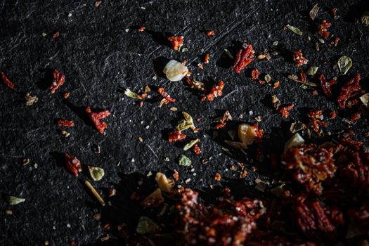 Dried tomato and chili pepper closeup on luxury stone background as flat lay, dry food spices and recipe ingredients