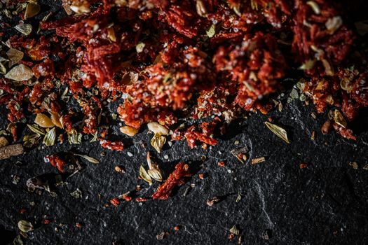 Dried tomato and chili pepper closeup on luxury stone background as flat lay, dry food spices and recipe ingredients