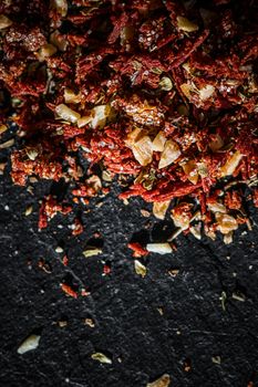 Dried tomato and chili pepper closeup on luxury stone background as flat lay, dry food spices and recipe ingredients