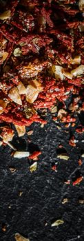 Dried tomato and chili pepper closeup on luxury stone background as flat lay, dry food spices and recipe ingredients