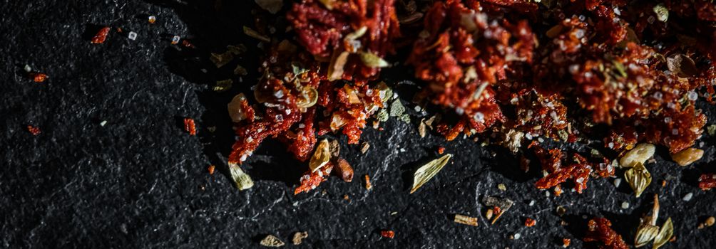 Dried tomato and chili pepper closeup on luxury stone background as flat lay, dry food spices and recipe ingredients