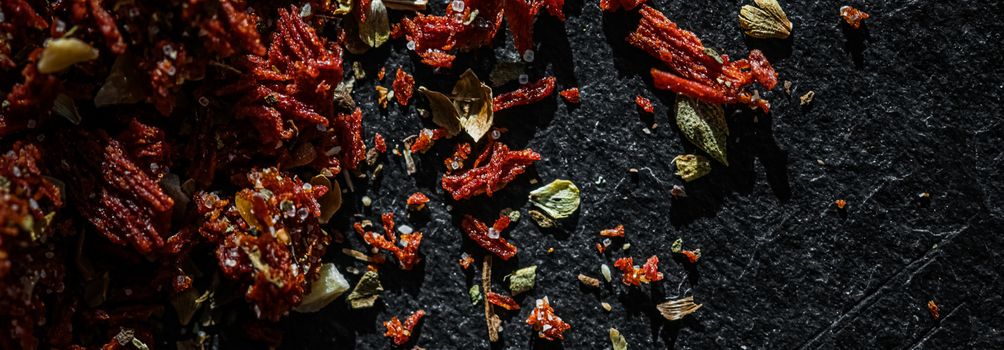 Dried tomato and chili pepper closeup on luxury stone background as flat lay, dry food spices and recipe ingredients