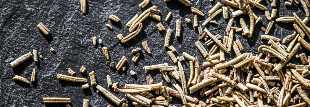 Rosemary closeup on luxury stone background as flat lay, dry food spices and recipe ingredients