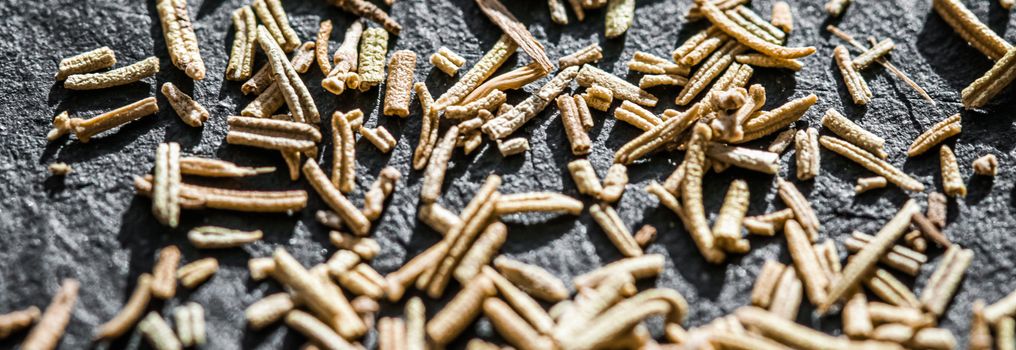 Rosemary closeup on luxury stone background as flat lay, dry food spices and recipe ingredients