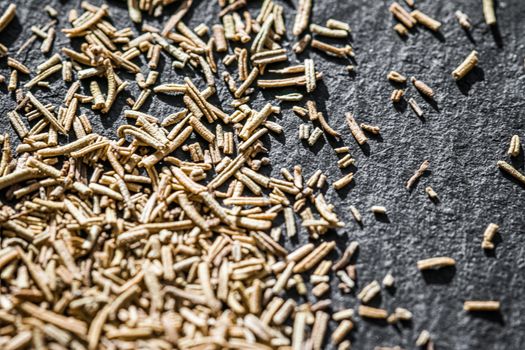 Rosemary closeup on luxury stone background as flat lay, dry food spices and recipe ingredients