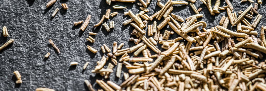 Rosemary closeup on luxury stone background as flat lay, dry food spices and recipe ingredients