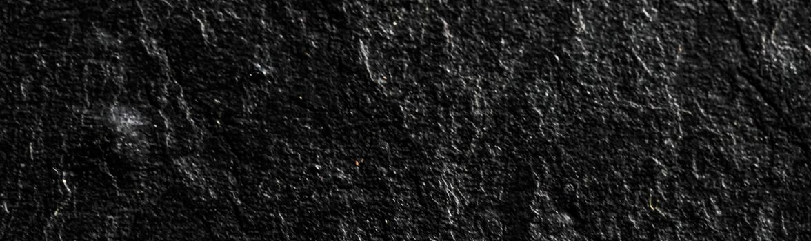 Black stone texture as abstract background, design material and textured surfaces