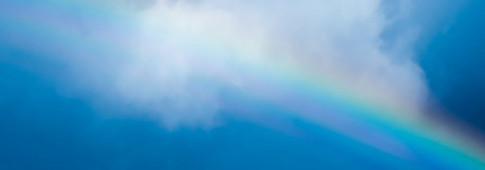 Rainbow in a dreamy blue sky, spiritual and nature backgrounds