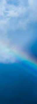 Rainbow in a dreamy blue sky, spiritual and nature backgrounds