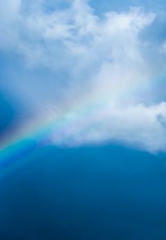 Rainbow in a dreamy blue sky, spiritual and nature backgrounds