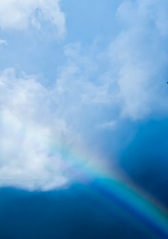 Rainbow in a dreamy blue sky, spiritual and nature backgrounds