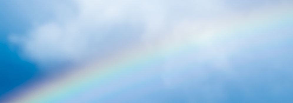 Rainbow in a dreamy blue sky, spiritual and nature backgrounds