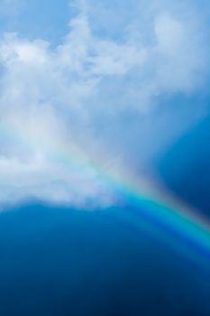 Rainbow in a dreamy blue sky, spiritual and nature backgrounds
