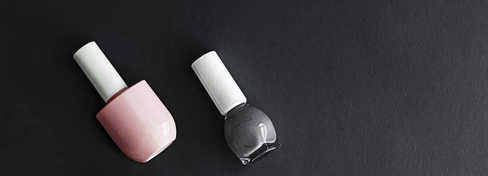 Nail polish bottles on black background, beauty branding