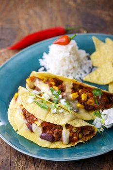 mexican tacos with rice on wood