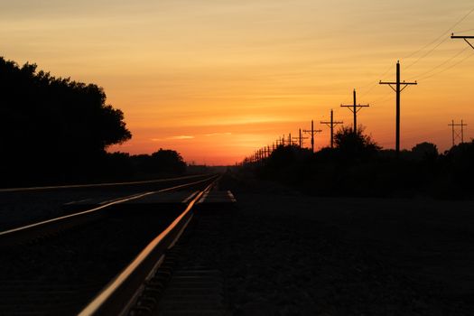 Rail Road crossing and tracks at sunset . High quality photo