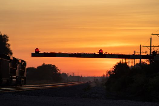 Rail Road crossing and tracks at sunset . High quality photo