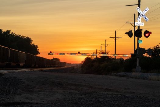 Rail Road crossing and tracks at sunset . High quality photo