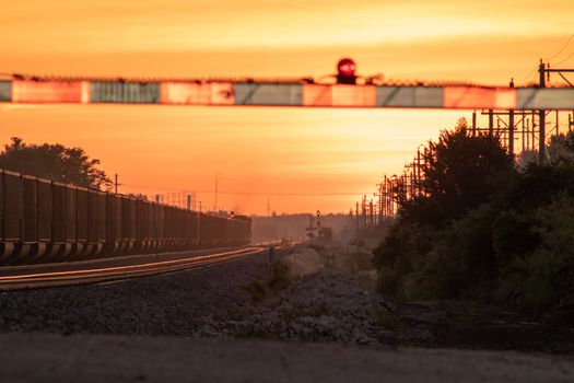 Rail Road crossing and tracks at sunset . High quality photo