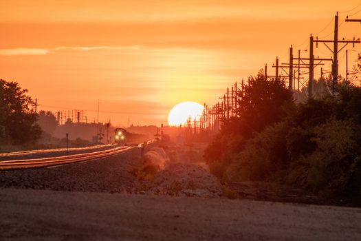 Rail Road crossing and tracks at sunset . High quality photo