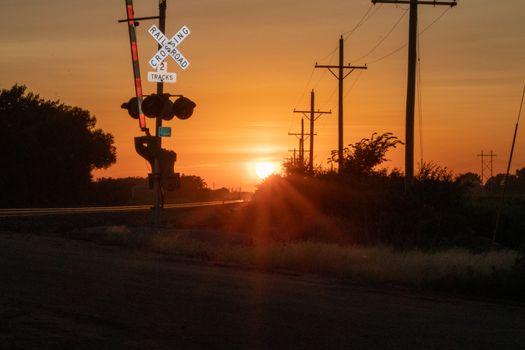 Rail Road crossing and tracks at sunset . High quality photo
