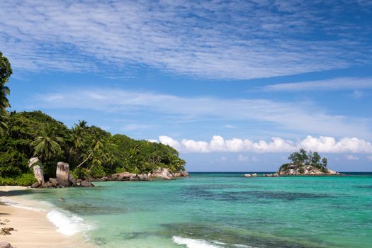 Beautiful beach with a small island in the near, Seychelles