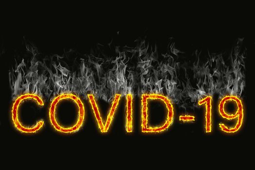 A designation of a Covid 19 virus as burning letters on a black background with smoke