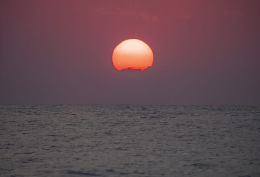 big sun down over sea sunrise, red sky