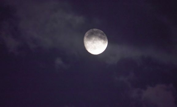 Full moon in night mystic sky with clouds