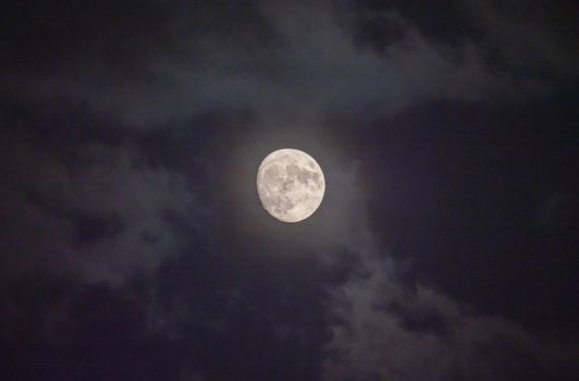 Full moon in night mystic sky with clouds