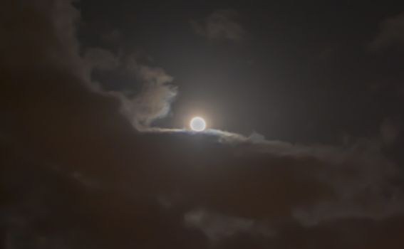 Full moon in night mystic sky with clouds