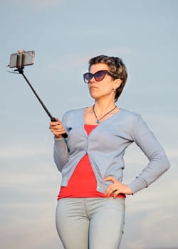 Woman taking a selfie against the sky