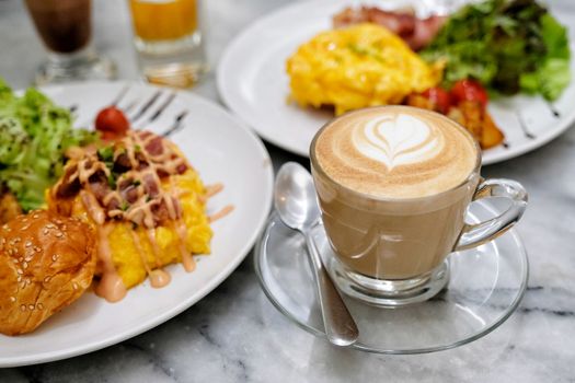 Coffee and Breakfast - fried egg, beans, tomatoes, mushrooms, bacon and toast.