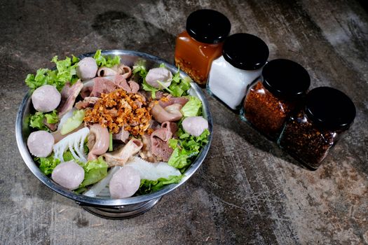 Thai style beef in a hotpot with vegetable on wood background