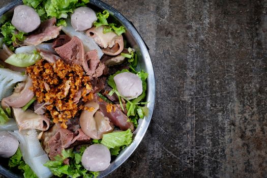 Thai style beef in a hotpot with vegetable on wood background